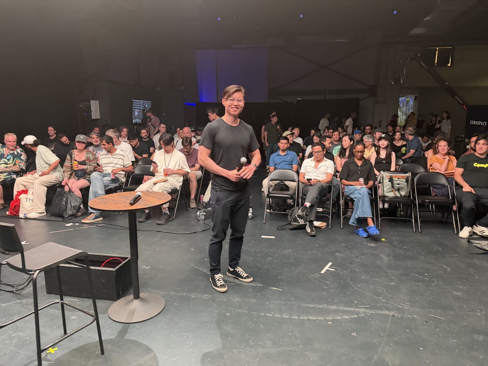 A presenter taking questions from the room